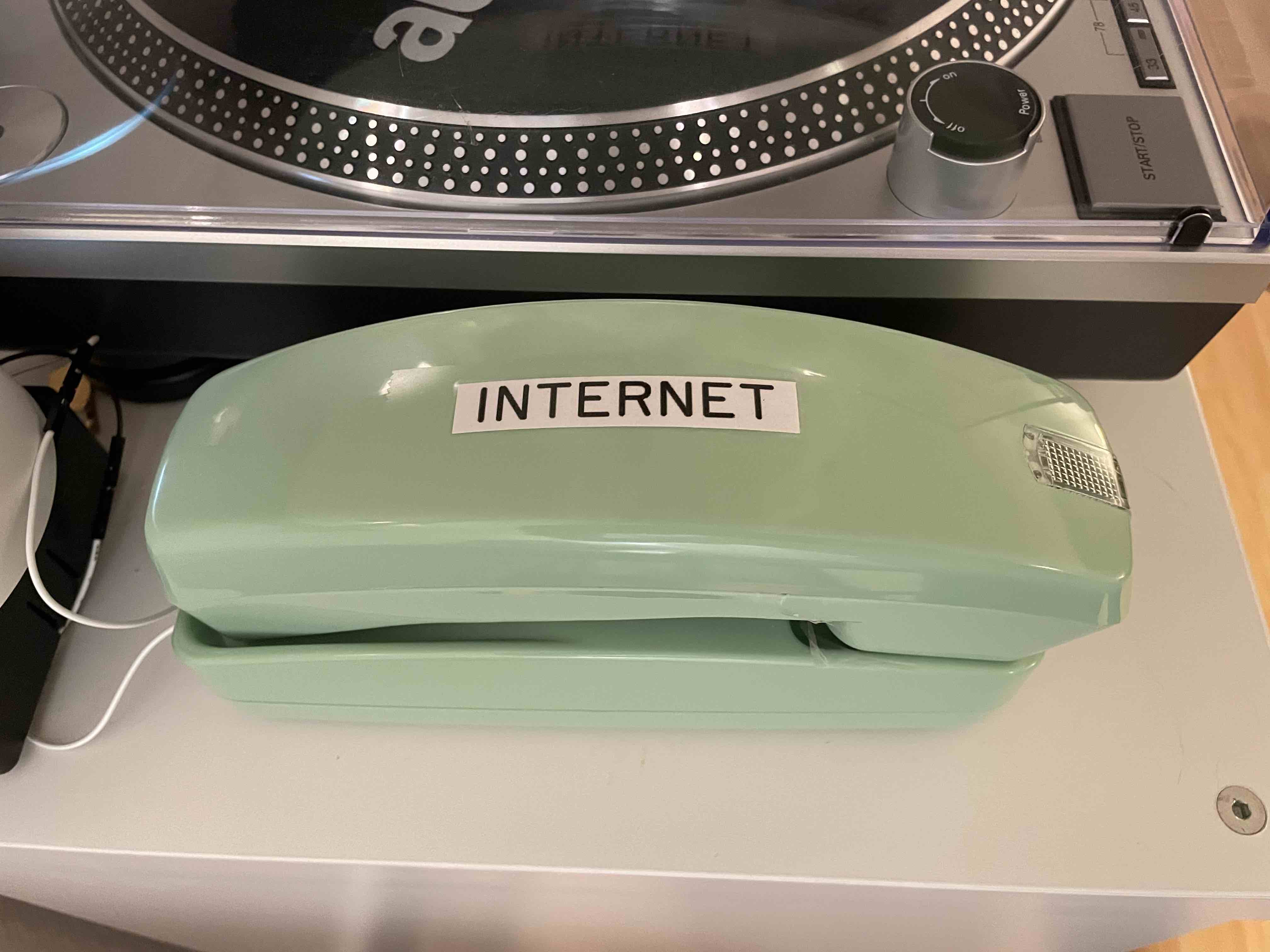 A green landline phone.